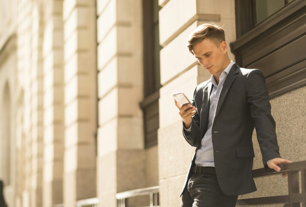 Businessman using phone, London, UK