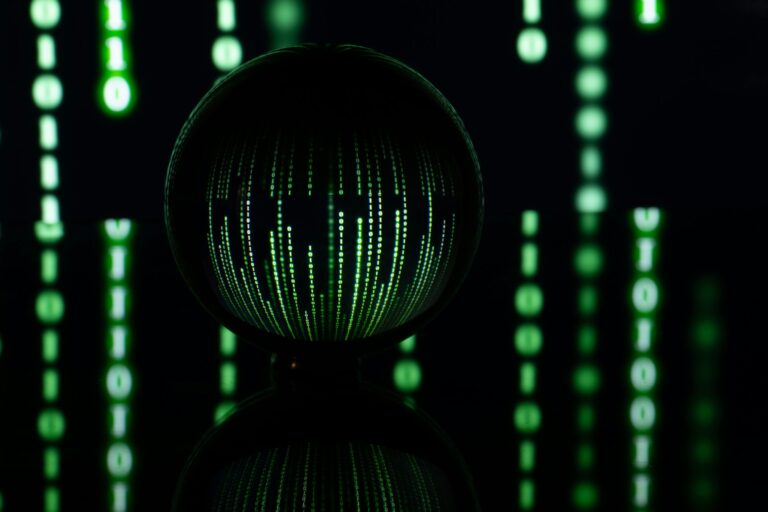 Dark background with computer binary code and a ball. Computer technology