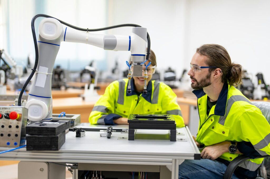 Engineer inspecting automatic AI robot arm and machines in factory. Engineer inspecting automatic AI