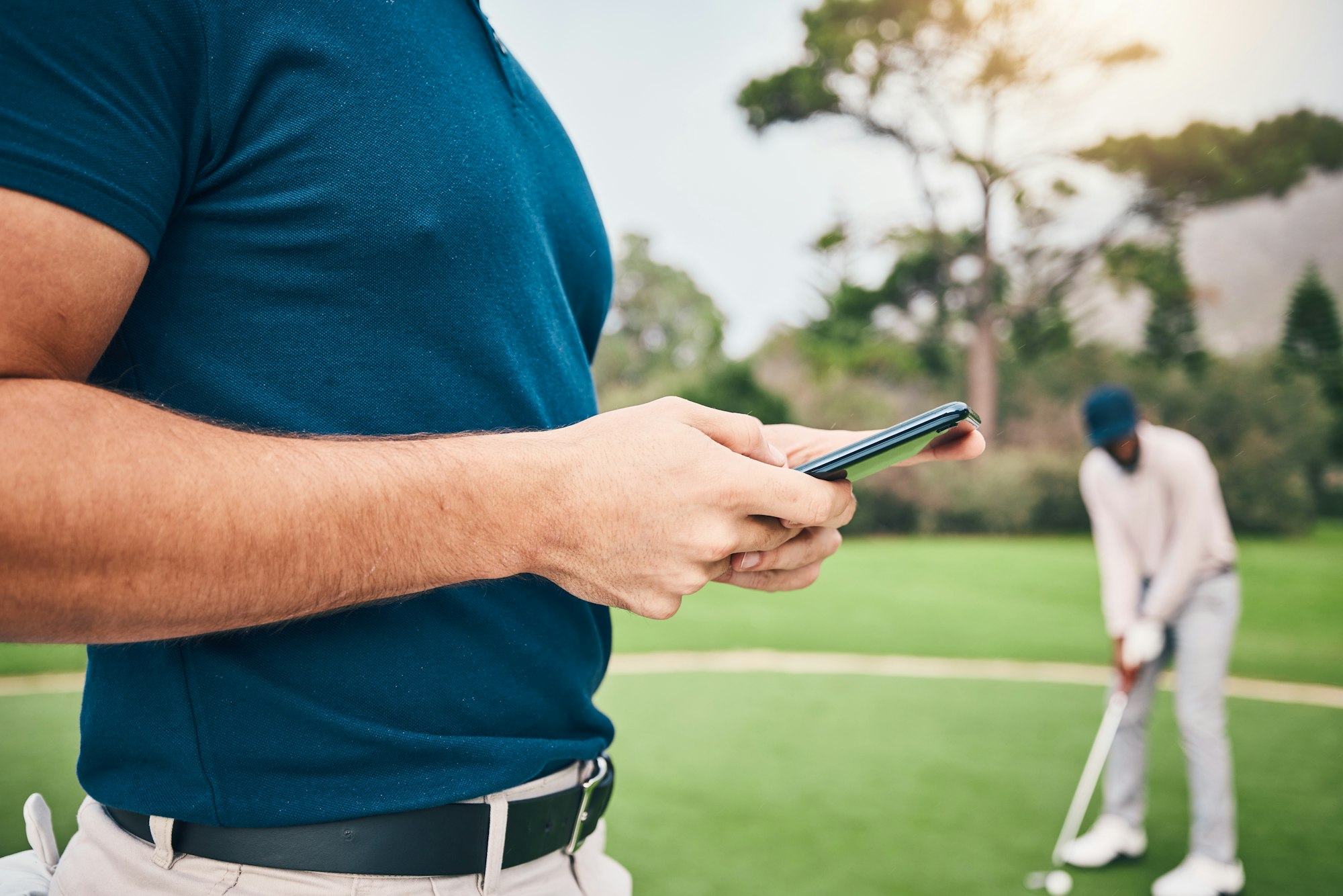 Man, hands and phone texting in communication on golf course for sports, social media or networking