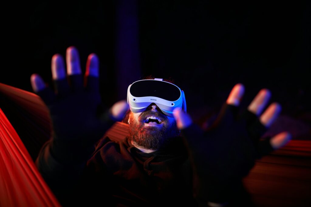 Portrait of a naughty man interacting with adult sex content with Virtual reality goggles at night