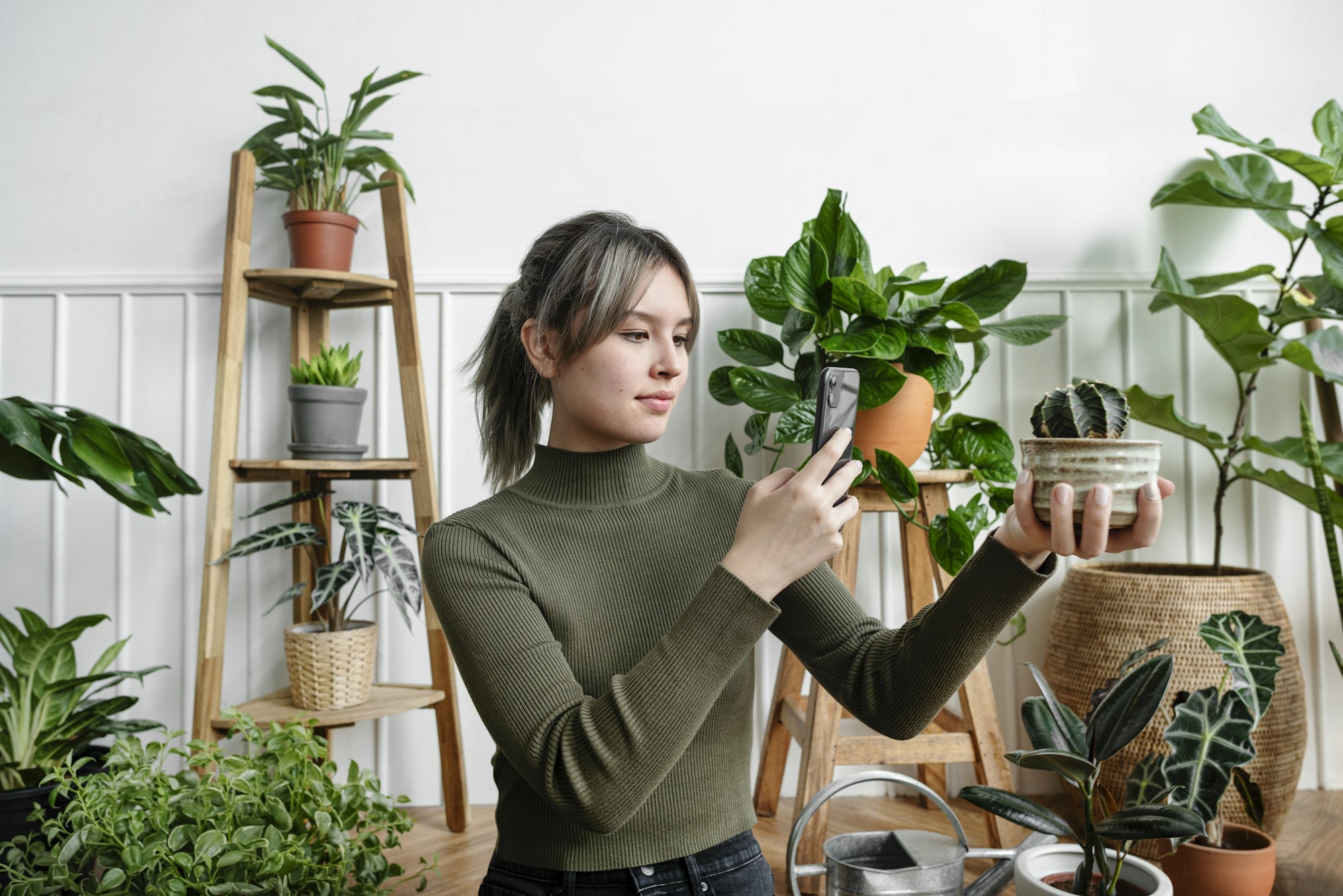 woman taking a snapshot of her plant for social media
