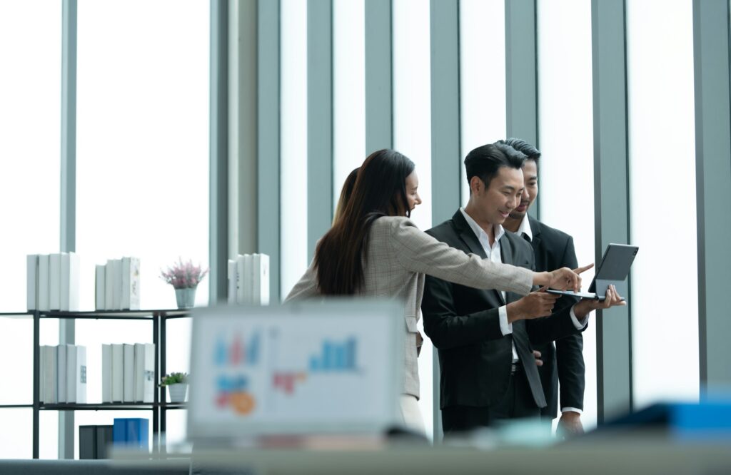 A group of young Asian entrepreneurs A meeting is being held to review stock investment information