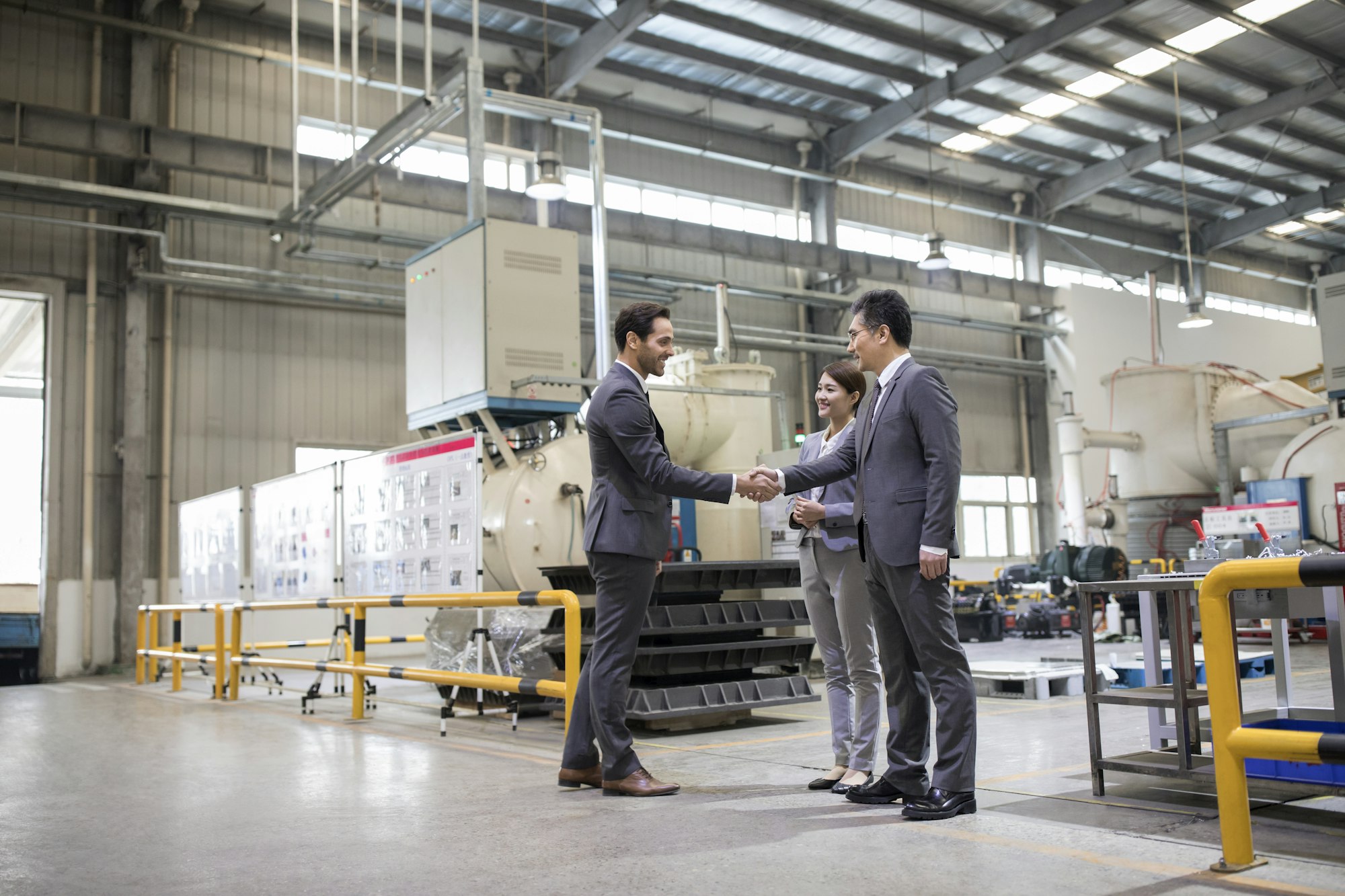 Business people shaking hands in the factory