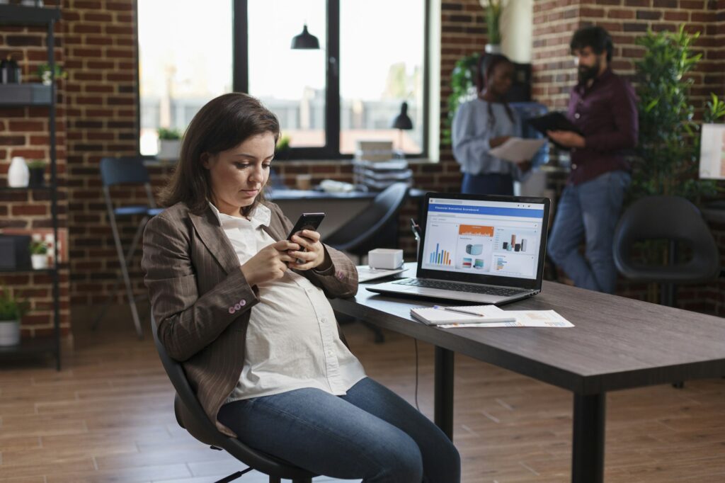 Future mother sending work related text messages to colleagues