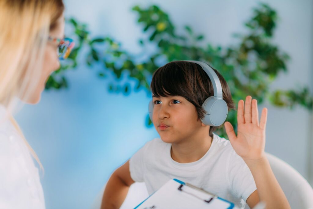 Hearing Test for Children. Audiologist Working with a Preschooler Boy