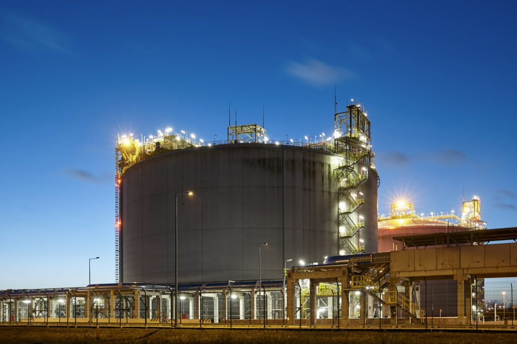 Liquefied natural gas storage tank at dusk.