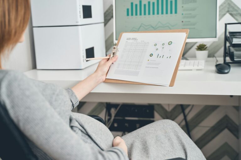 Pregnant lady holding results of global market energy research