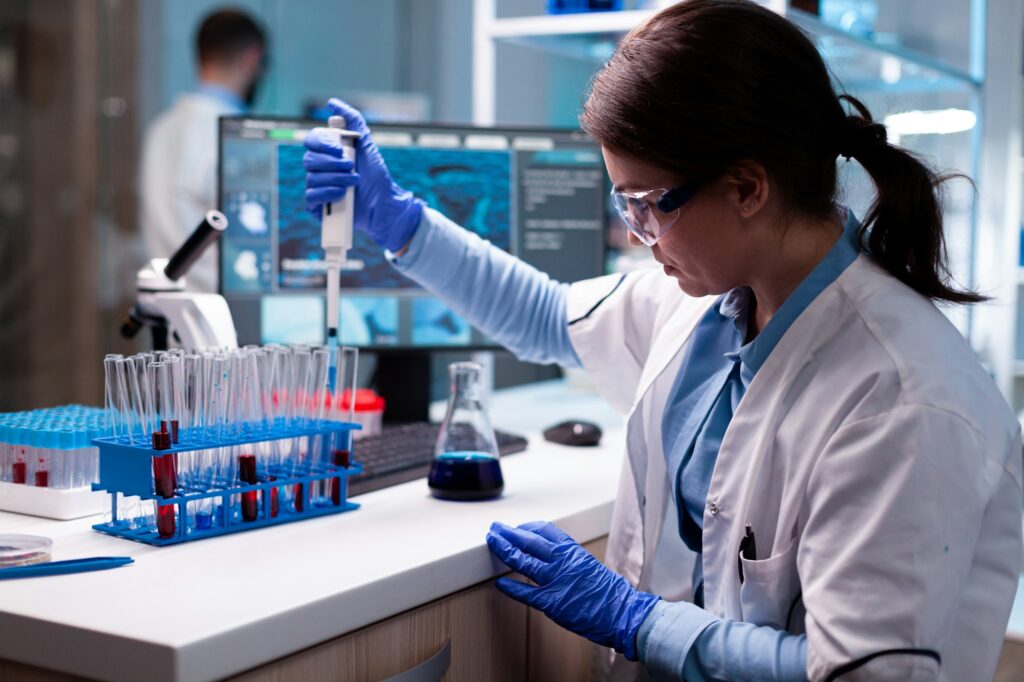 Scientist looking into micropipette for biology test