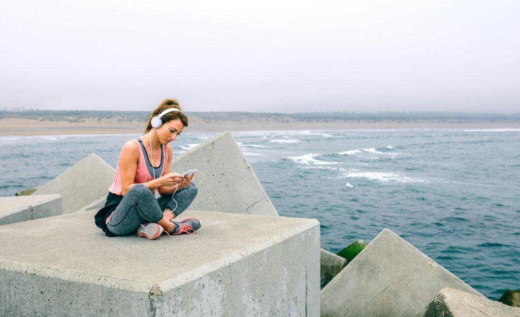 Sportswoman with headphones sitting