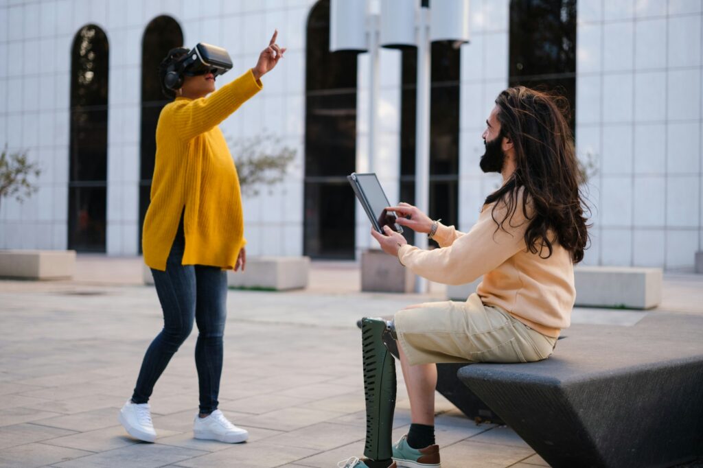 Two workers using virtual reality to do their work outdoors. Concept: technology, investment