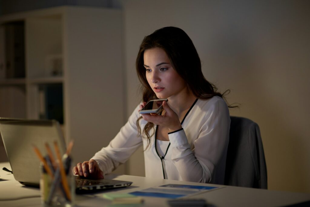 woman using voice command recorder on smartphone