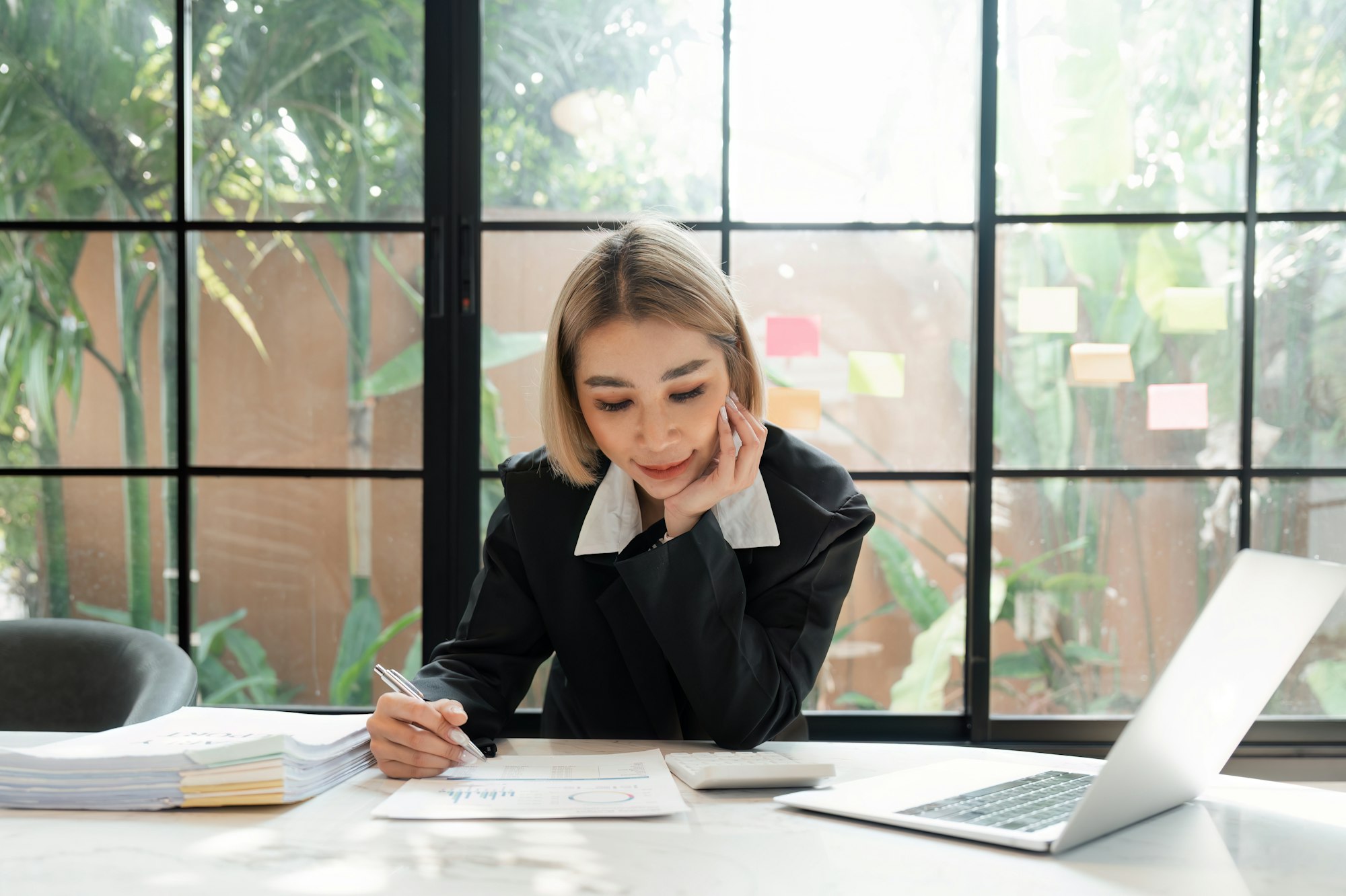 Young business woman, or company employee accounting bookkeeping documents checking financial data