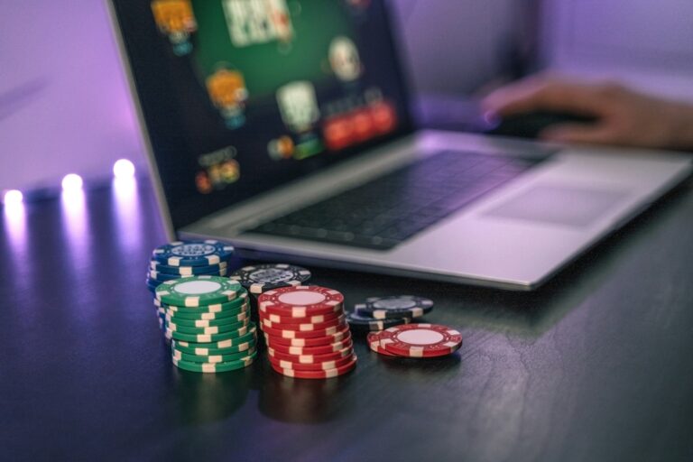 Young man play online poker in laptop.