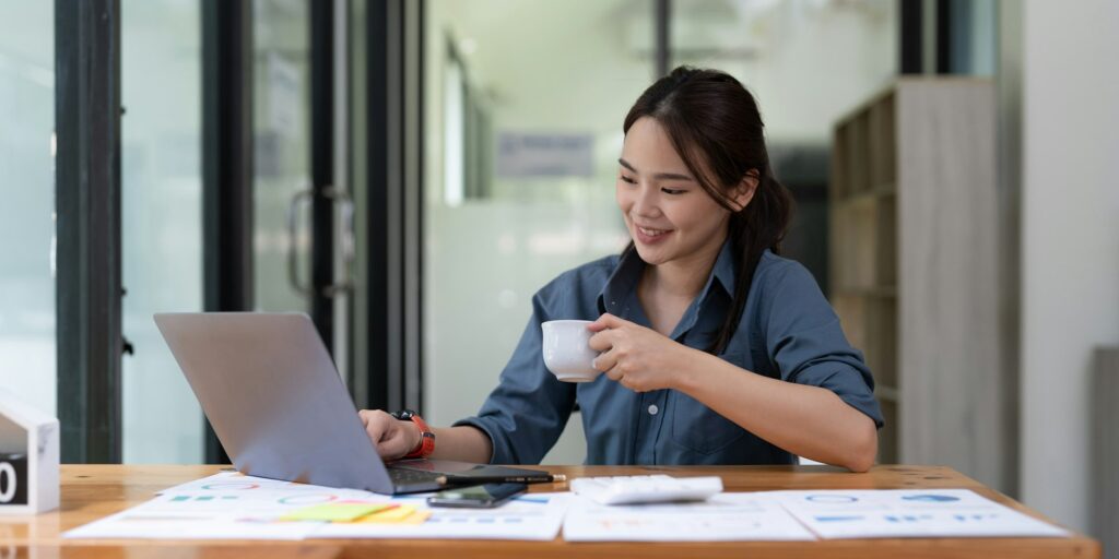 Young woman using laptop while working for business financial investment.