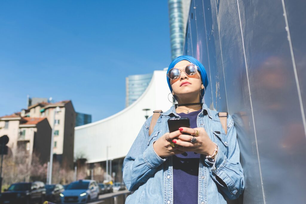 Arabian young woman wearing hijab using smart phone