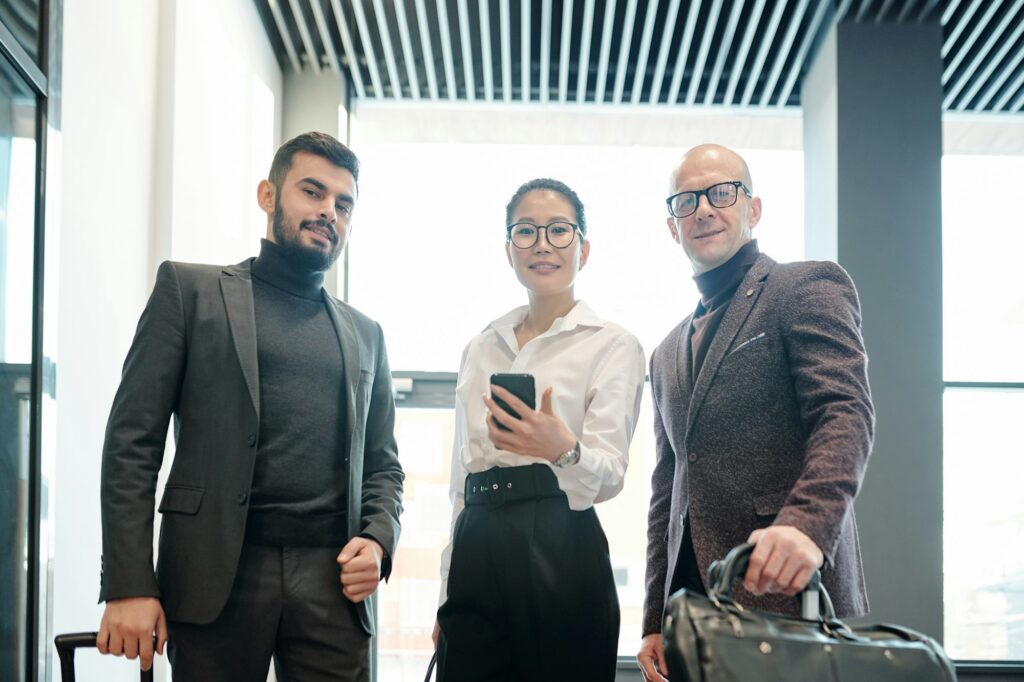 Group of successful colleagues searching for right way to hotel in the net