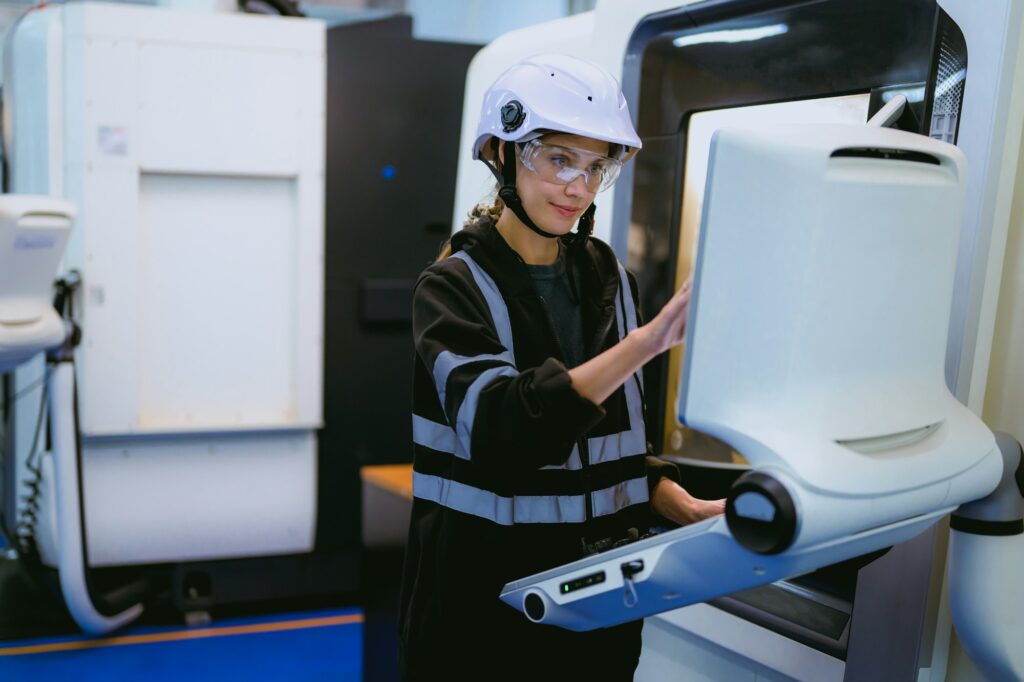 Professional technician checking and repairing part of automatic machine