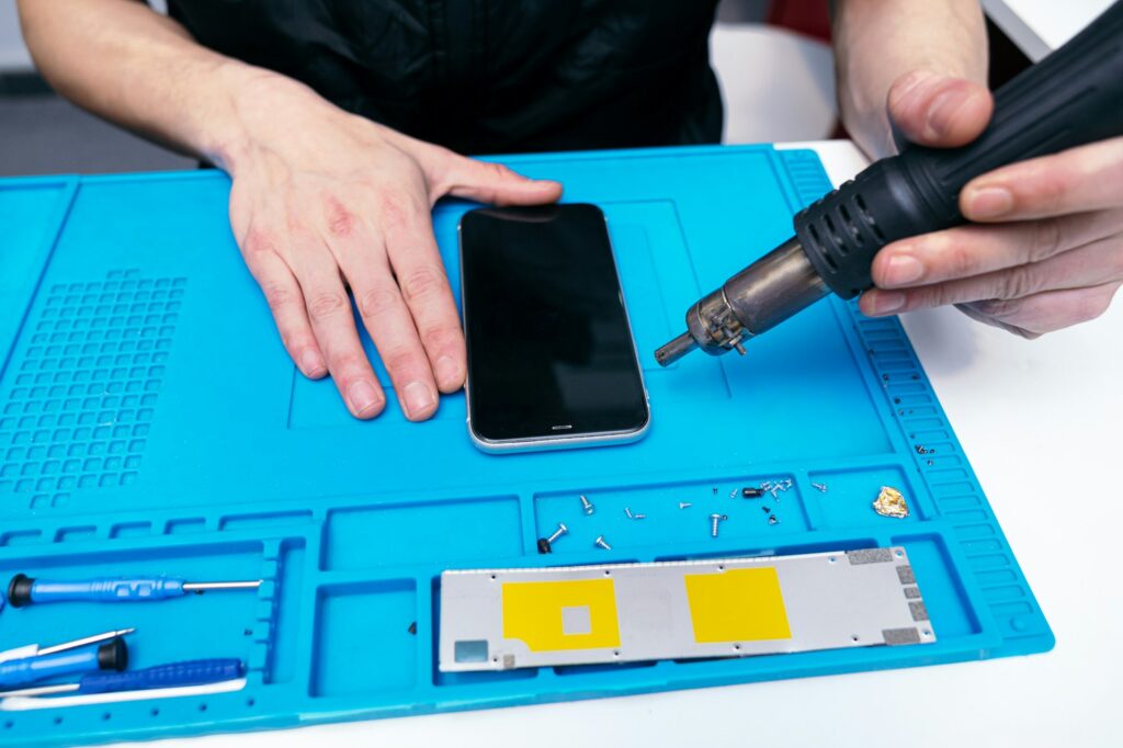 Skilled Technician Carefully Dismantling a Smartphone