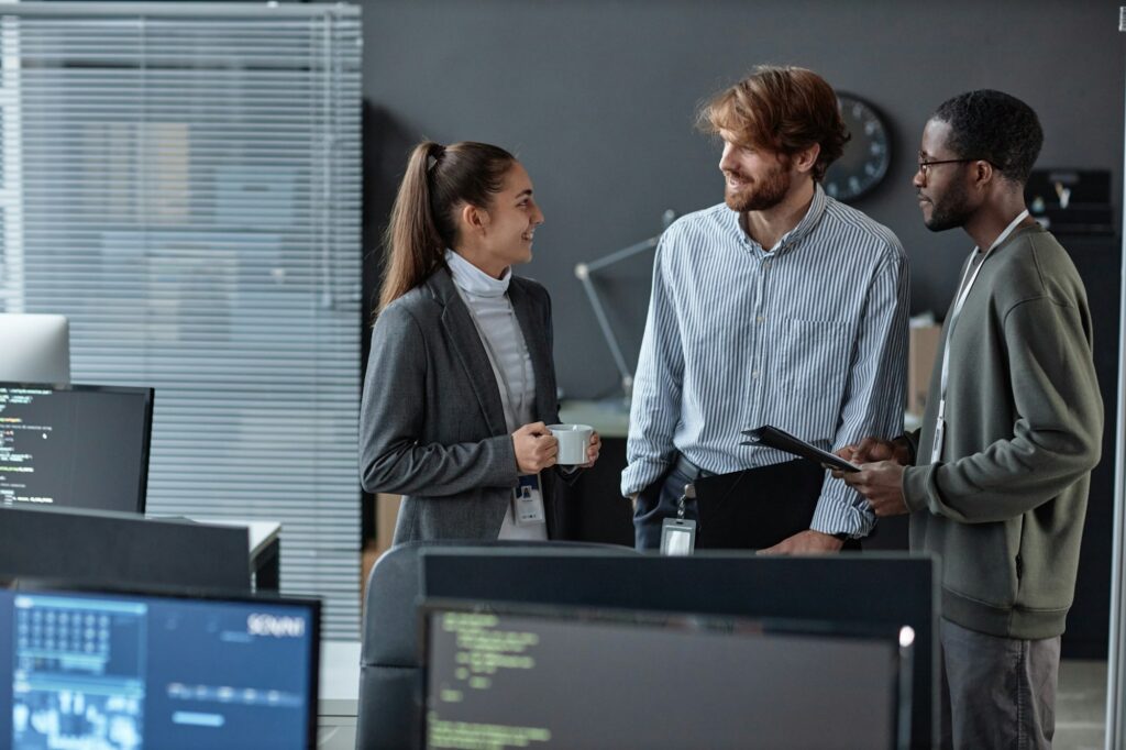 Team Of Three Young People Standing in Formal Office