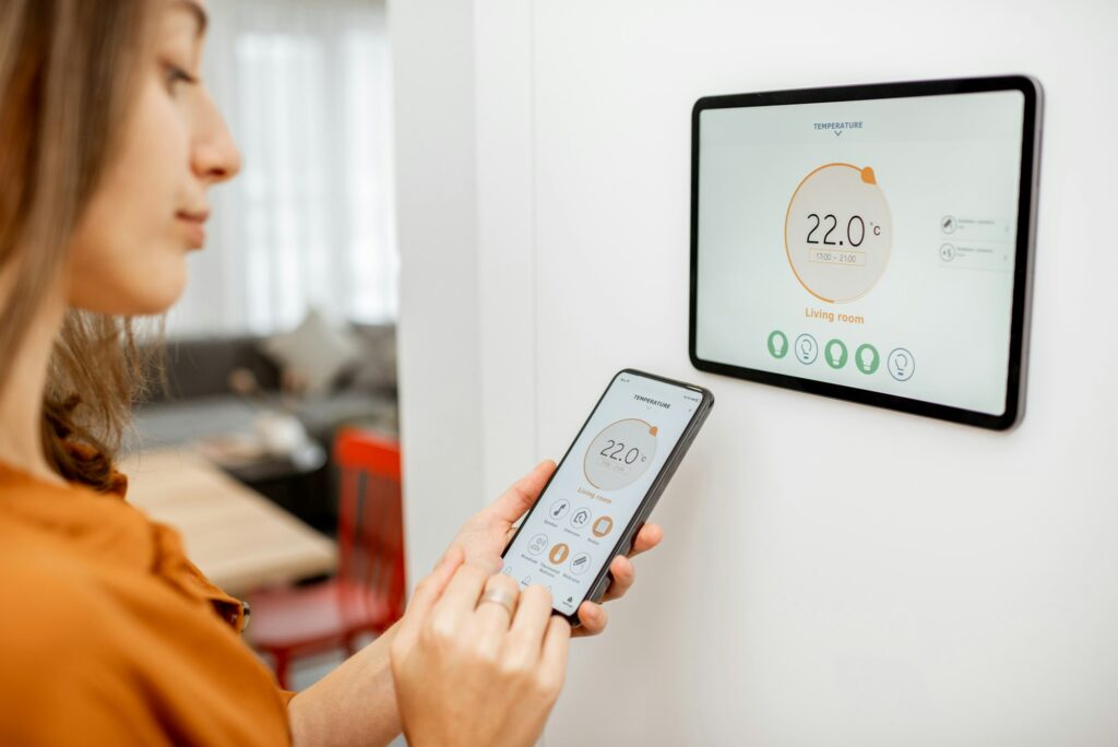 Woman controlling heating with a smart devices