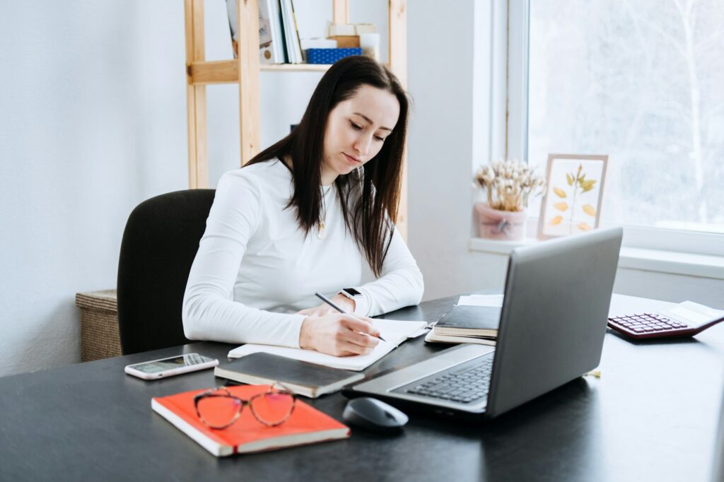 Accounting Formulas Equations for Accountants. Female Accountant working with calculator and laptop