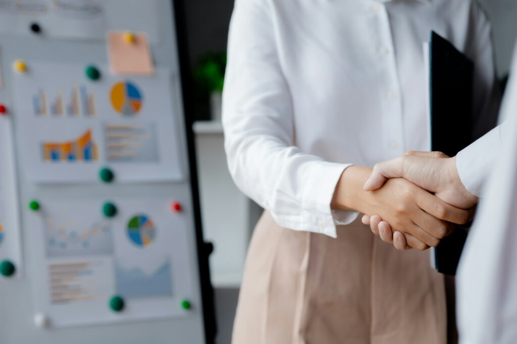 Business investor group holding hands.