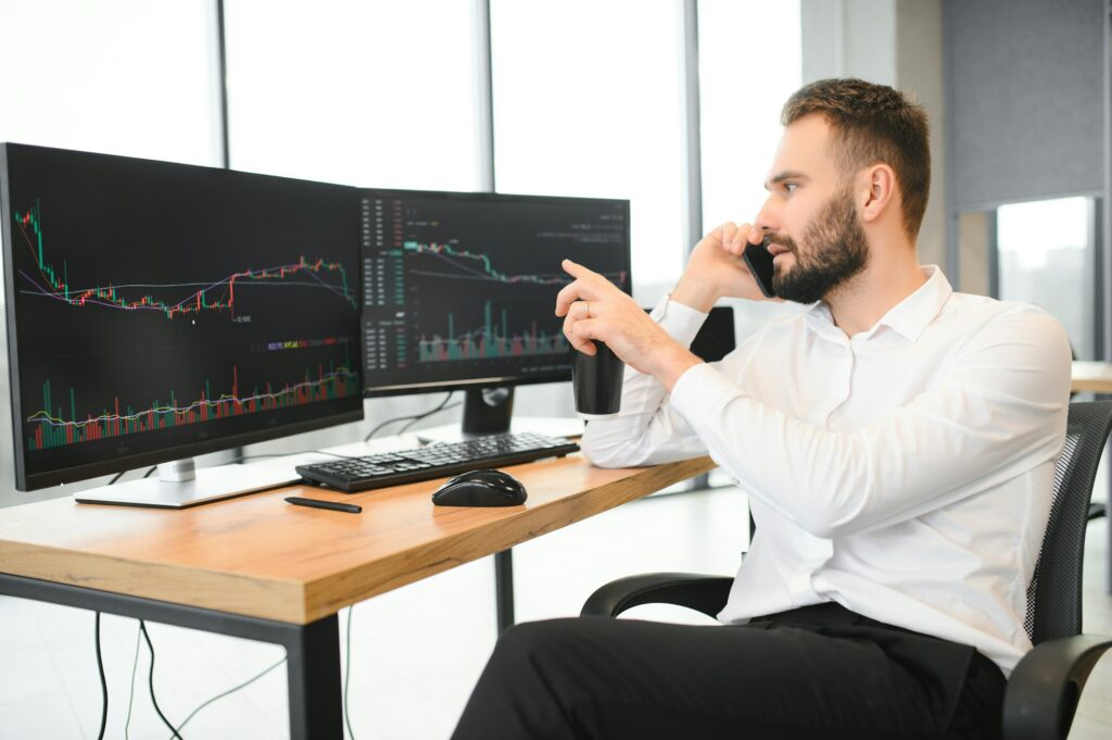 business man looking at the charts of the stock market of cryptocurrencies on the PC screen