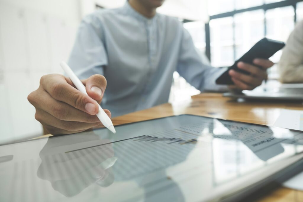 Businessman is analyzing investment project data from data report.