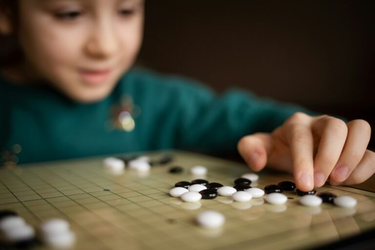 child playing game go. board logic strategy game for developing mind