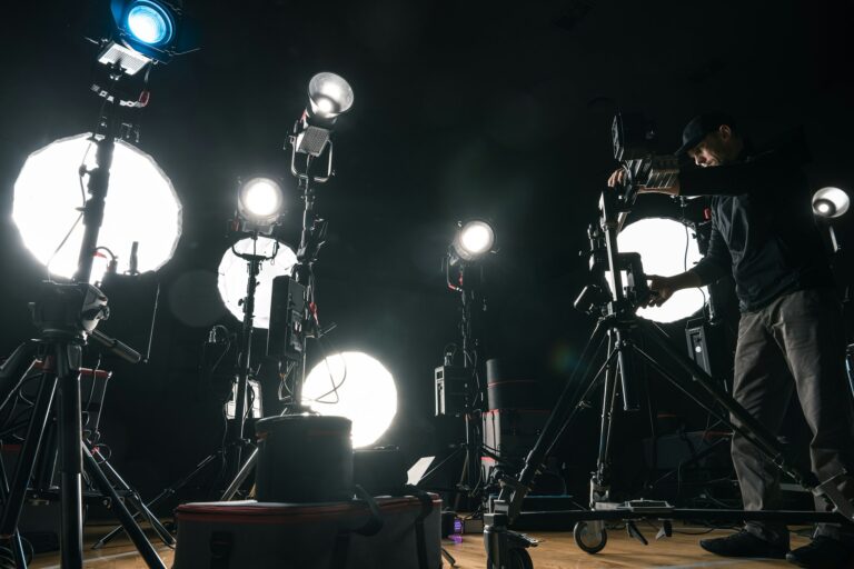 Filmmaker Adjusting Camera Lighting On Set