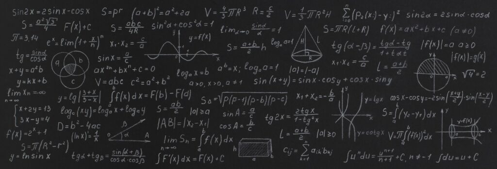 Formulas and calculations from mathematics and geometry on school blackboard