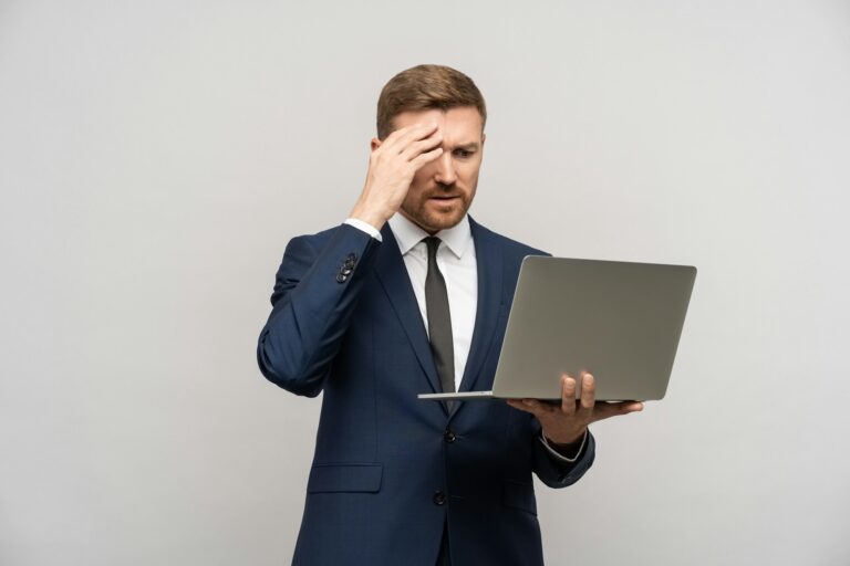 Frustrated trader man with laptop in hands. Business collapse, difficulties, financial problems