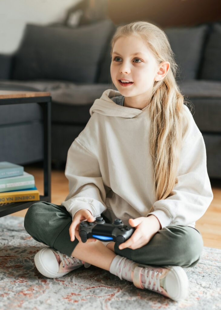 Girl playing video game at home