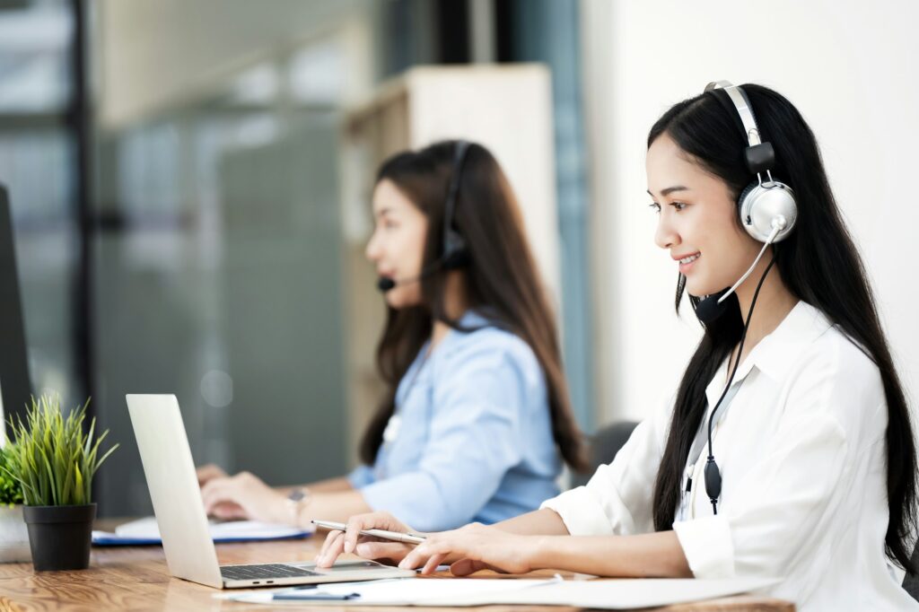 Group of female operator working in the office and communication network concept. Customer service.