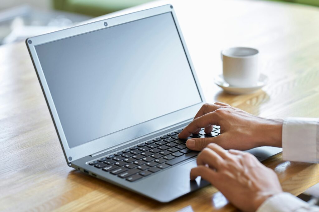 Hands of a businessman typing on a laptop