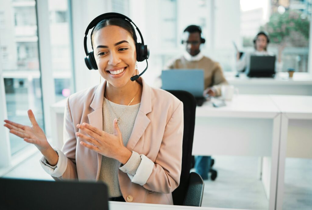 Happy woman, laptop and call center with headphones consulting in customer service or telemarketing