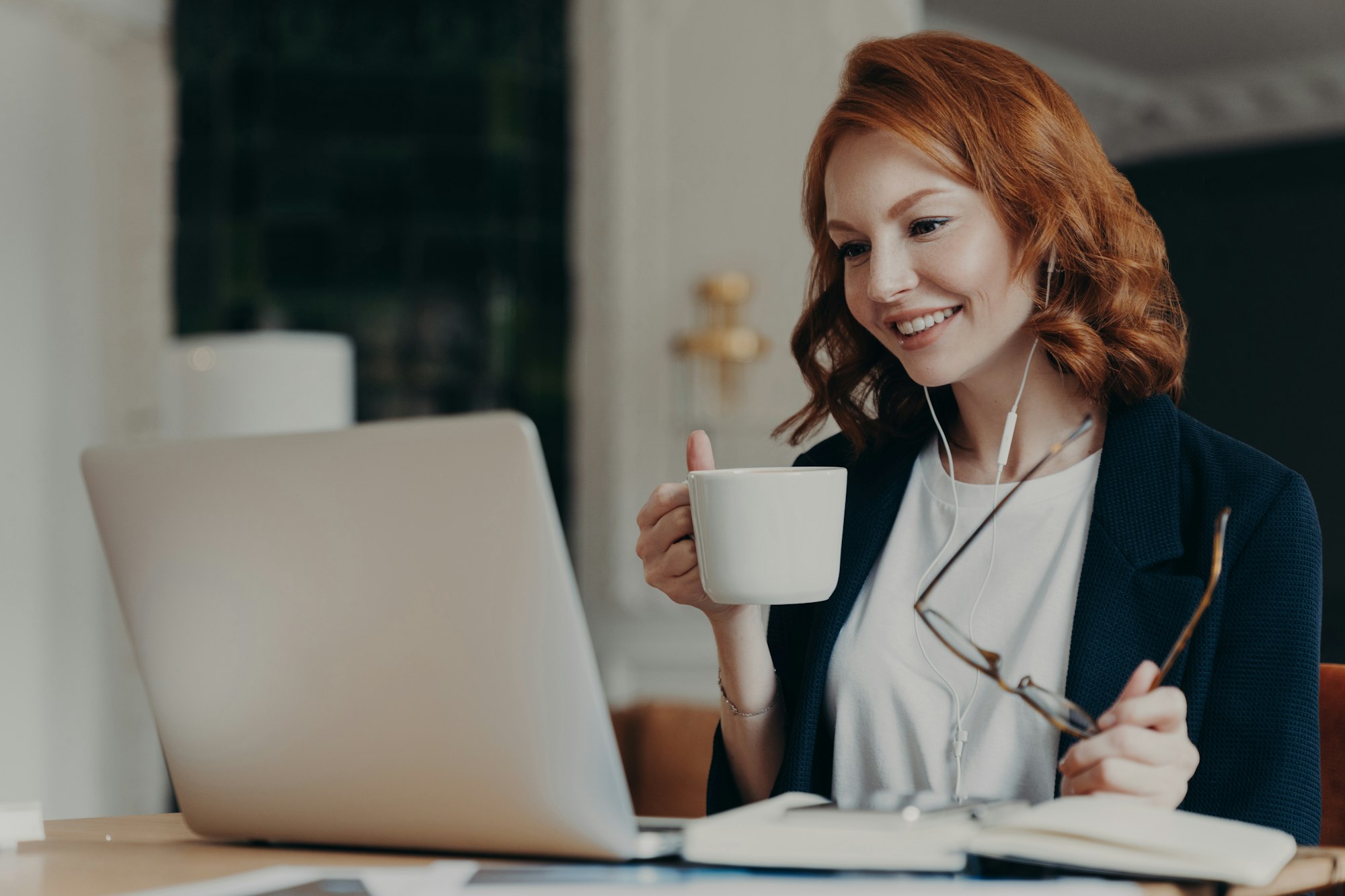 Intelligent female student has online course, concentrated in screen of laptop computer