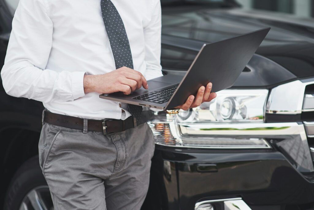 Man is a man working on a laptop and testing on mobile devices