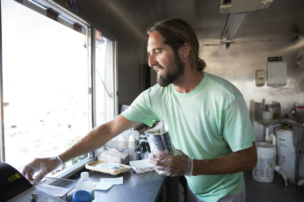 Man preparing order in fast food trailer