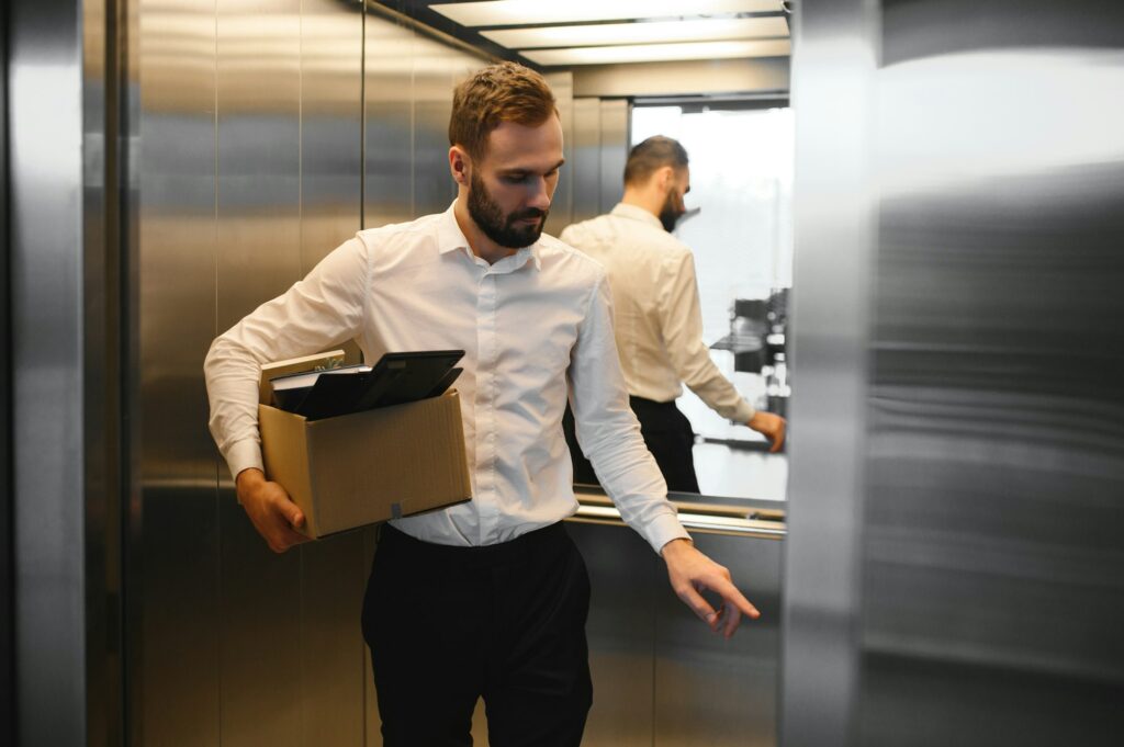 Mature bearded office worker feeling upset after being resigned from successful company