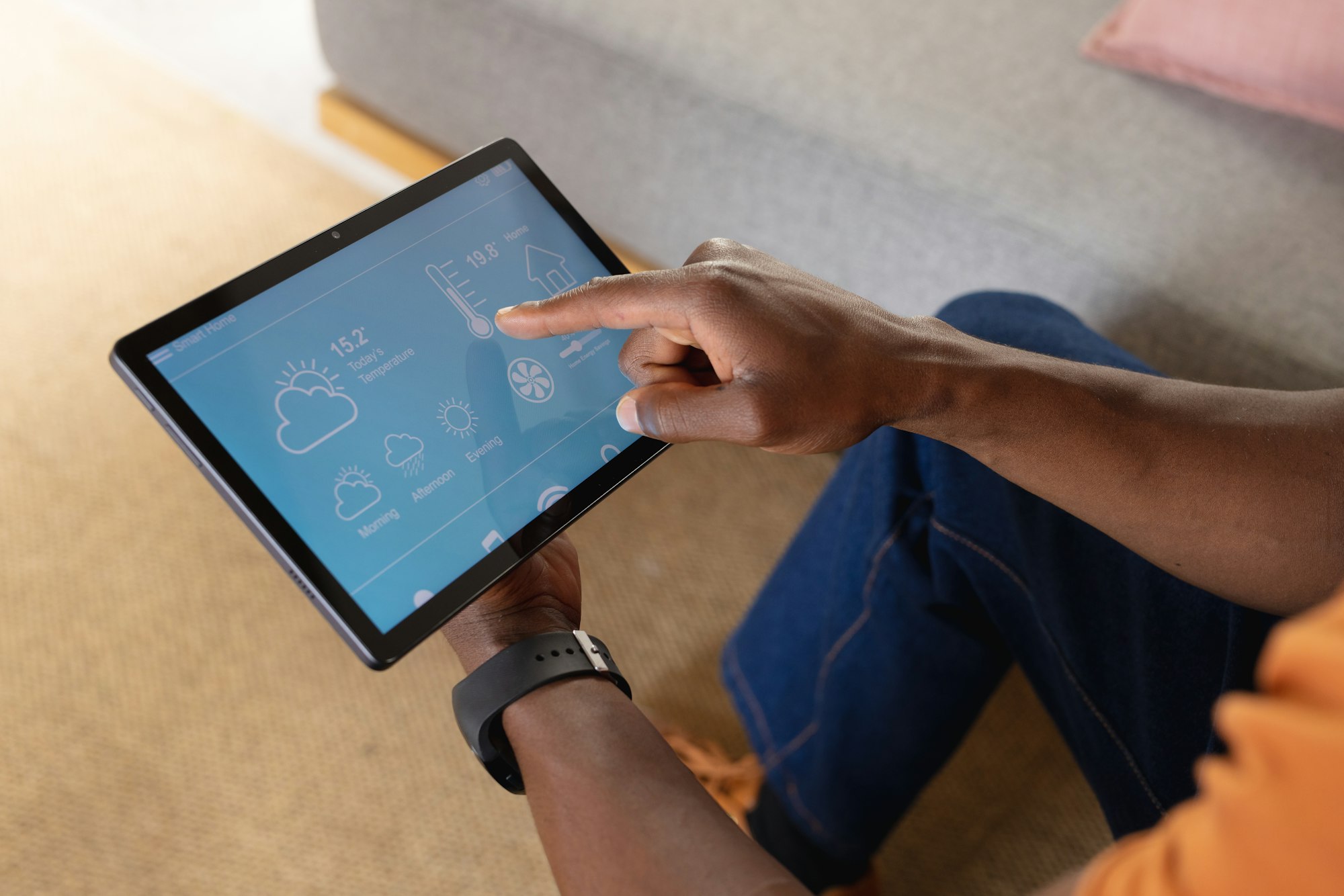 Midsection of african american man using tablet with weather forecast