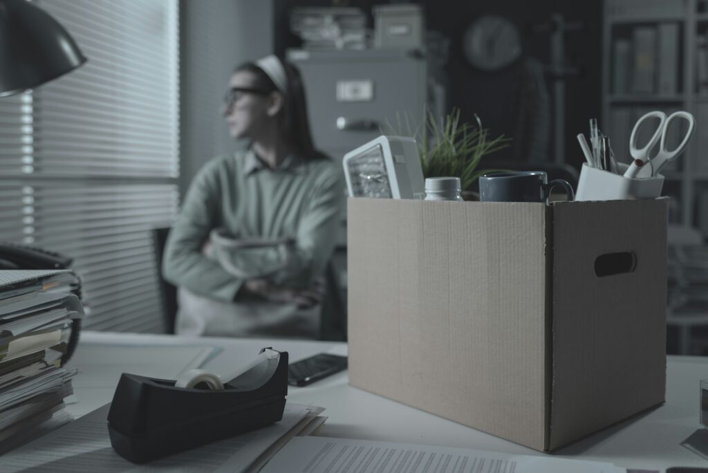 Pensive woman in the office packing her belongings