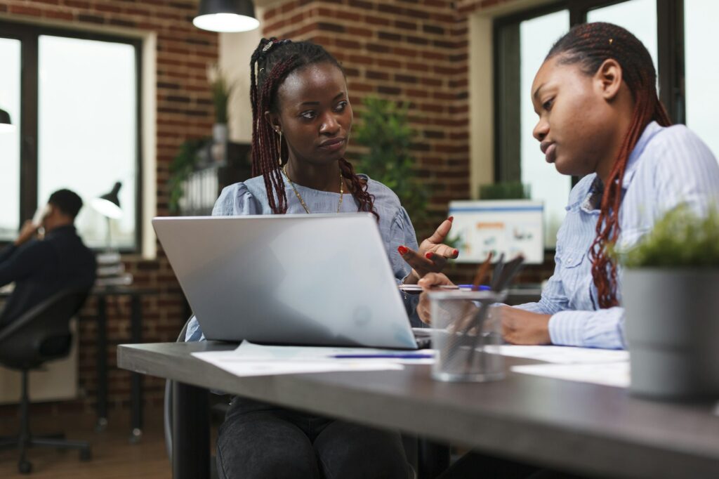 Research and development company office employees reviewing financial report