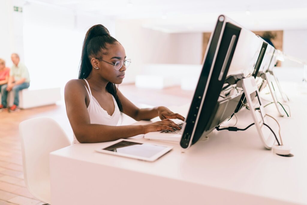 skilled teenager in spectacles using high technology for research connected to internet