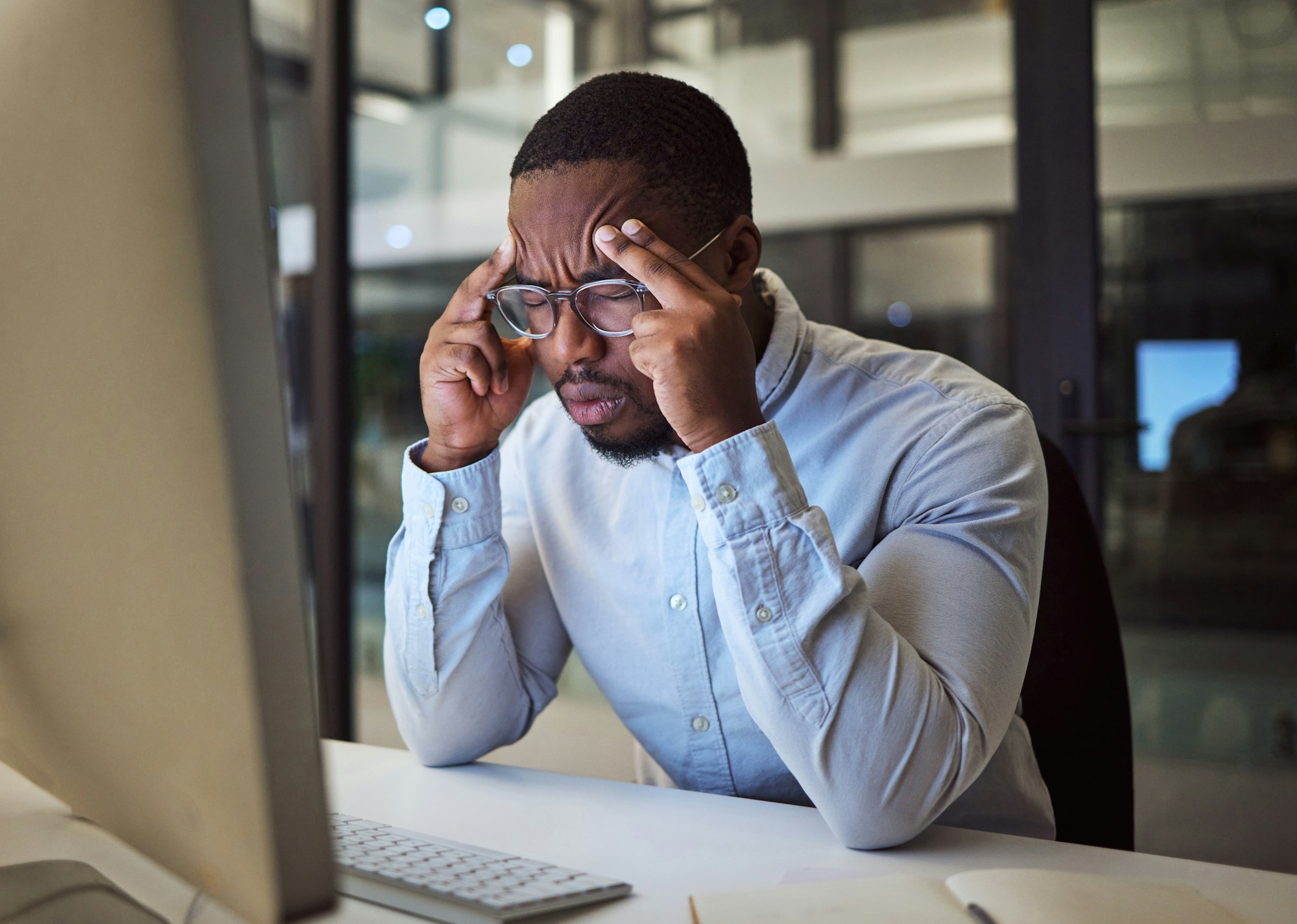 Stress, headache and black businessman on night office computer with 404 software glitch, cybersecu