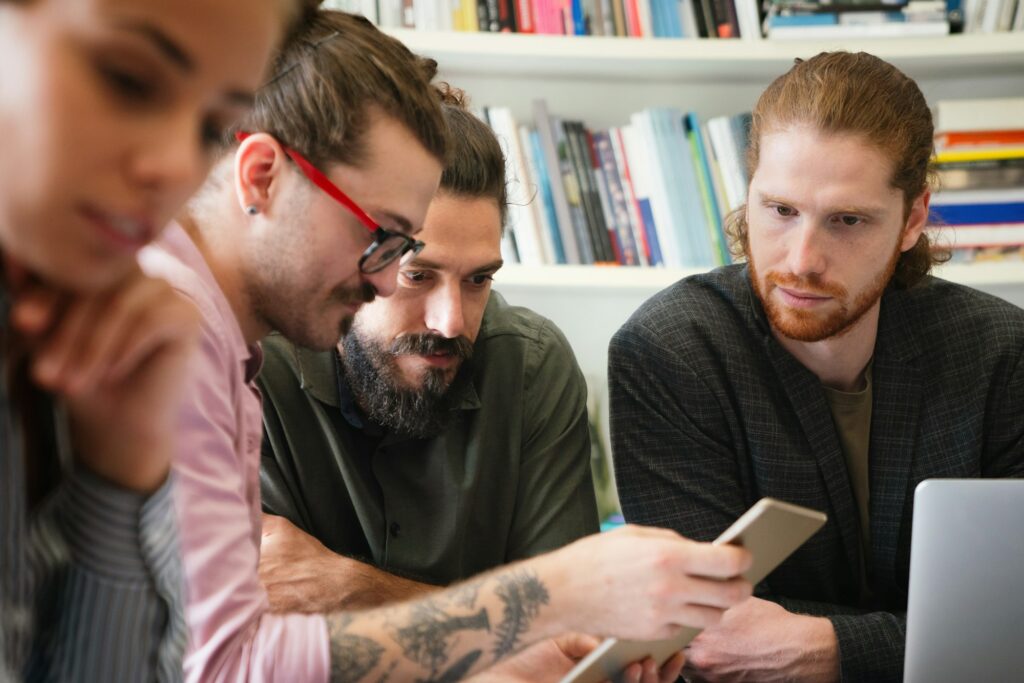 Team of multiethnic diverse young software developers talk, discuss an AI project. Business startup