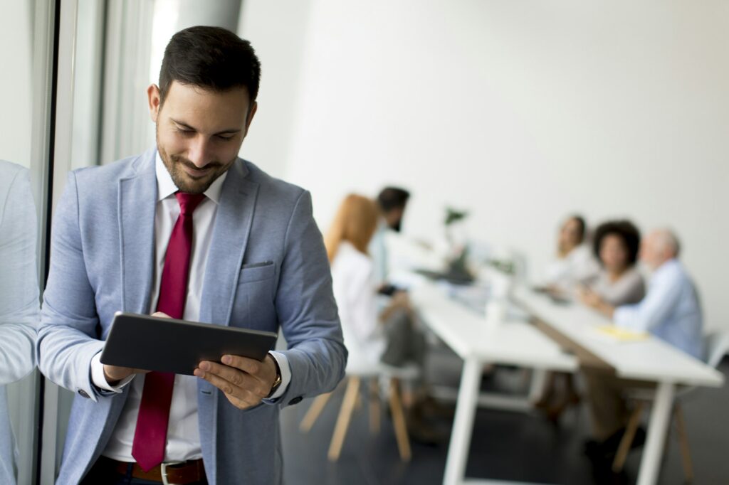 Young businessman with digital tablet in office