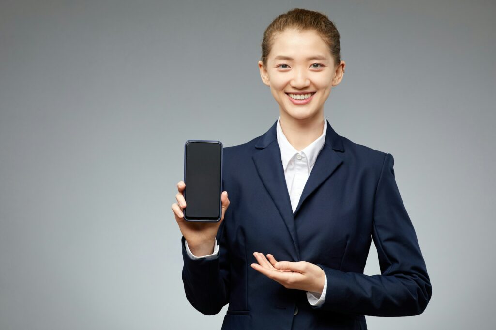 Asian Woman Presenting Smartphone Mockup