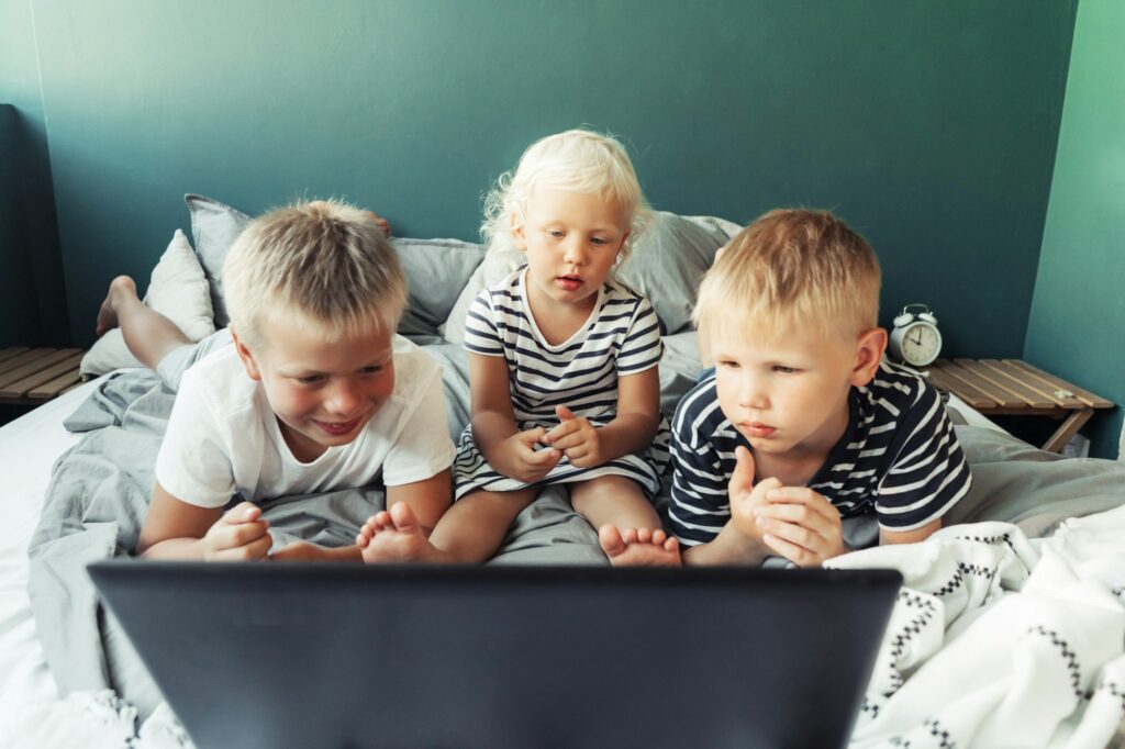 Children look at the laptop screen